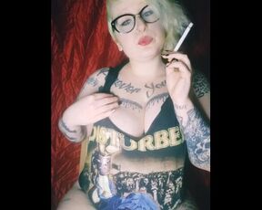 Metal girl smokes a cigar