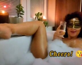 Happy New Year 2023! Champagne cheers in a bathtub in company of vibrator